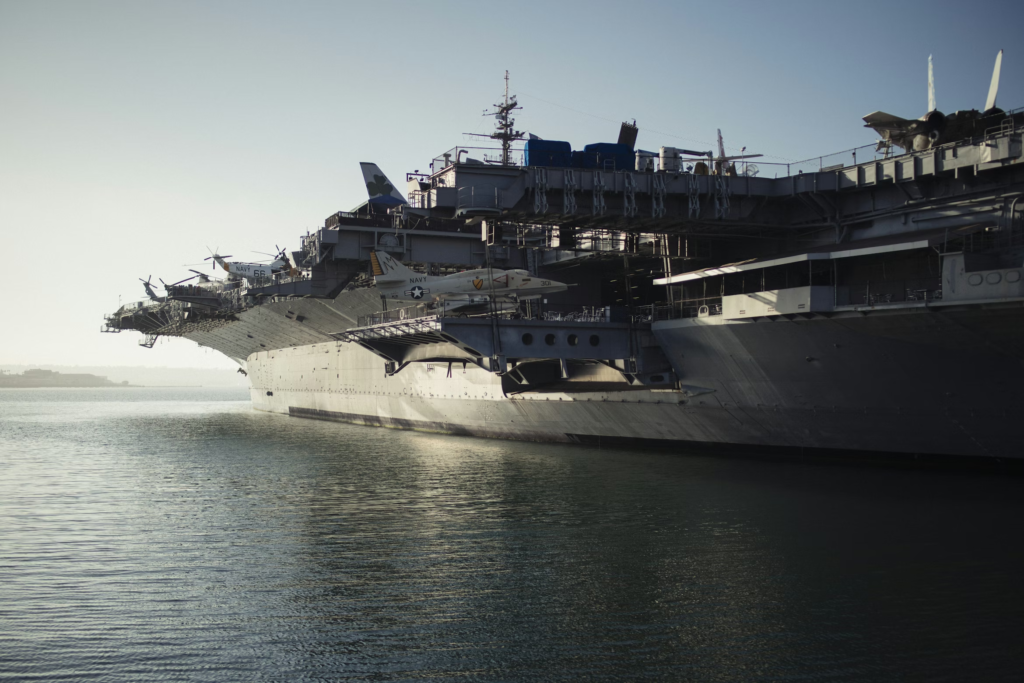 Naval aircraft carrier sailing into port